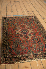 Vintage Dargezine rug from an angle, highlighting its brick red field and dense floral medallion.