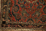 Vintage Dargezine rug corner showing floral spray motifs and a worn, machine-bound side.