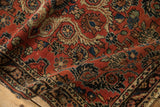 A vintage Persian Dargezine rug showing textured low pile and Rococo stylized floral motifs.