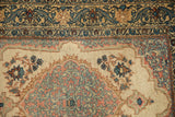 Elaborate arabesque main border and scalloped corner detail on a vintage Persian Tabriz rug.