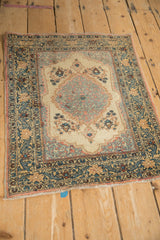 Full angled view of a vintage Tabriz rug, showcasing its scalloped medallion and arabesque borders.