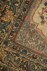 Close-up of the vintage Tabriz rug's intricate meandering vine and palmette border.