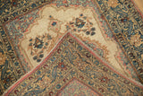 Folded corner of a vintage Tabriz rug showing the hand-knotted back and side selvage.