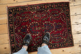 Vintage Sarouk rug mat with a cherry red field, shown from above for scale.