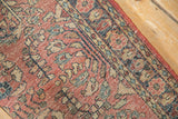 Angled close-up on the even pile and detailed floral motifs of a vintage Sarouk rug.