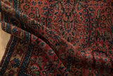 Vintage Lilihan rug's raspberry floral sprays and sapphire blue vine palmettes on its dense pile.