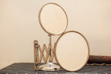 Antique shaving mirror set with standing and expandable beveled glass mirrors and aged metal patina.