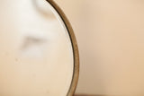 Detail of the antique shaving mirror's beveled edge and attractive metal patina.