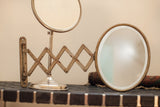 Unique oval expandable shaving mirror with scissor-arm and attractive patina.