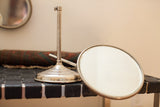 Polished silver base and beveled oval frame from the antique shaving mirror set.