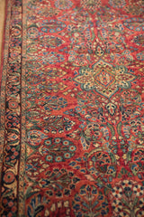Vintage Sarouk runner's cherry red field with curvilinear floral and serpent border.
