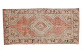 Vintage Distressed Oushak rug runner, faded brick red, ivory, brown geometric floral medallion. 2'7