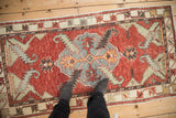 Textural distressed Oushak runner, showing even wear and cherry red geometric patterns.