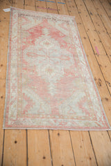Vintage distressed Oushak runner corner with pale blush, silver hues and mostly even wear.