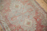 Distressed Oushak rug runner with worn pile, pale blush motifs, and visible oxidized silver foundation.