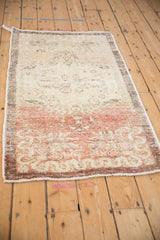 Angled view of a distressed Turkish Oushak runner showing its abrashed, faded dye lots.