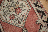 Vintage Distressed Oushak rug with serrated medallion, abrashed brick red and pale seafoam green.