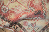 The soft, flexible drape of a distressed vintage Oushak rug highlighting its low, worn pile.