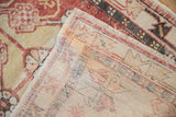 The reverse side of a distressed Turkish Oushak rug showing its hand-knotted foundation.