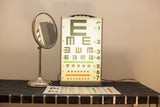 Graham Field illuminated Snellen E-chart on light box with an antique shaving mirror.