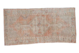 Vintage distressed Oushak runner rug with a stepped hexagonal medallion in soft sandalwood and seafoam green.