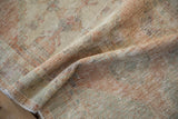 Close-up showing the soft, worn texture and exposed knot heads of a distressed Oushak rug.