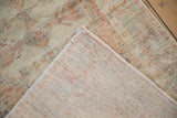 Hand-knotted foundation and distressed low pile of a vintage Turkish Oushak rug corner.