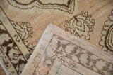 The hand-knotted foundation and secured edge of a vintage distressed Oushak rug.