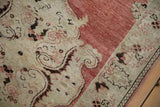Close view of cypress tree buds and stylized vines on the distressed, low-pile border.