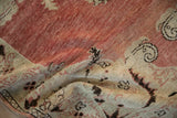 A close view of the vintage Oushak rug's soft, worn pile and abrashed dusty red field.