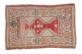 Vintage distressed Oushak rug with a raspberry medallion and playful geometric florals in seafoam and orange.