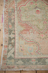 Unique dye lot variation with oxidized silver and seafoam green in a vintage Oushak's distressed border.