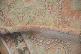 A soft fold in the vintage distressed rug reveals the texture of the low, hand-knotted pile.