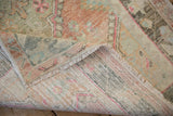 A view of the hand-knotted foundation on the back of a vintage distressed Oushak rug.