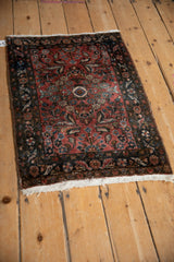 Textured pile of vintage Persian Dargezine rug corner with dusty rose field and navy floral border.