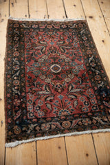 Dense bouquet of dusty rose and navy floral motifs on the vintage Dargezine rug.