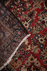 Intact side cord selvage and hand-knotted back of a vintage floral German Sarouk rug.