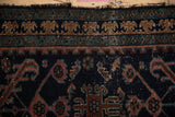 Antique Mehriban rug border, ram's horn and bat contour motifs with aged texture.