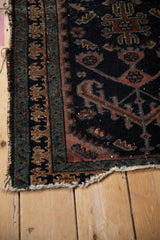 Antique Mehriban rug with tattered side, detailed dusty raspberry Laleh Abbasi pawn border.
