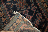 Antique Mehriban rug corner with tattered fringe, showing dark pile wear and woven foundation patterns.