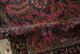 Textured pile of vintage Lilihan rug runner showing raspberry field, blue and green sprawling floral vines.