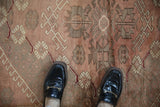 Vintage Anatolian rug with dusty rose and greige geometric hook and latch pattern.