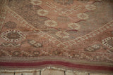 Anatolian rug border with running T and hook motifs, dusty rose, and a cherry red selvage.