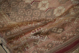 Vintage Anatolian rug side showing perimeter border, dusty rose tones, and time-softened pile.