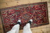 Vintage Sarouk runner with cherry red and blue floral sprays shown for scale.