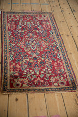 Angled view of the vintage American Sarouk runner showing its cherry red field and floral sprays.