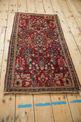 Angled view of a traditional American Sarouk runner's allover floral pattern on a rich red field.