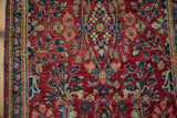 Fine weave showing the cherry red field and sapphire blue floral sprays of a vintage Sarouk rug.