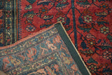 Vintage Lilihan rug's dark green secured selvage, intricately woven foundation, and raspberry red pile.