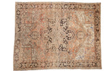 Vintage distressed Heriz rug, a starburst medallion in dusty rose, brown, and ivory tones.